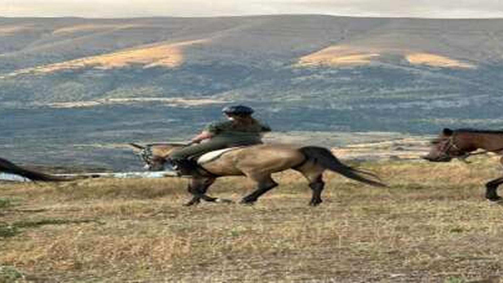 Horseback riders crossing the landscape above Gjirokastra