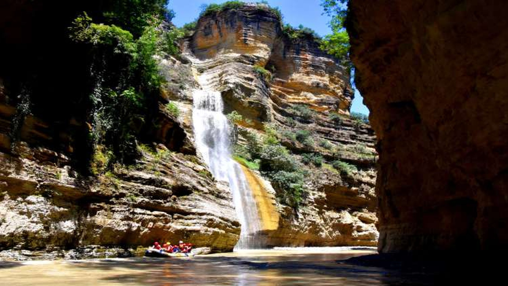 Waterfall and dramatic rock walls inside the Osum Canyons