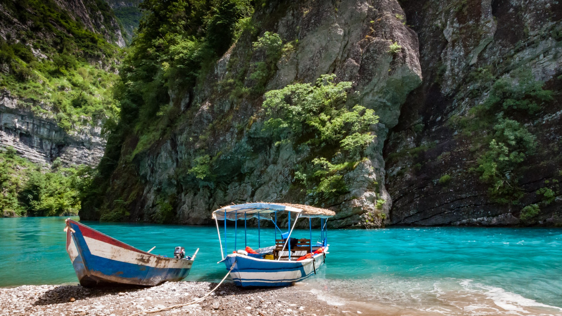 Boat on the turquoise waters of Lake Koman in northern Albania