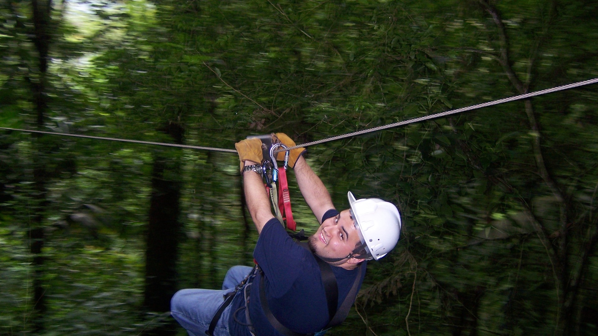 Adventure traveller riding a forest zipline